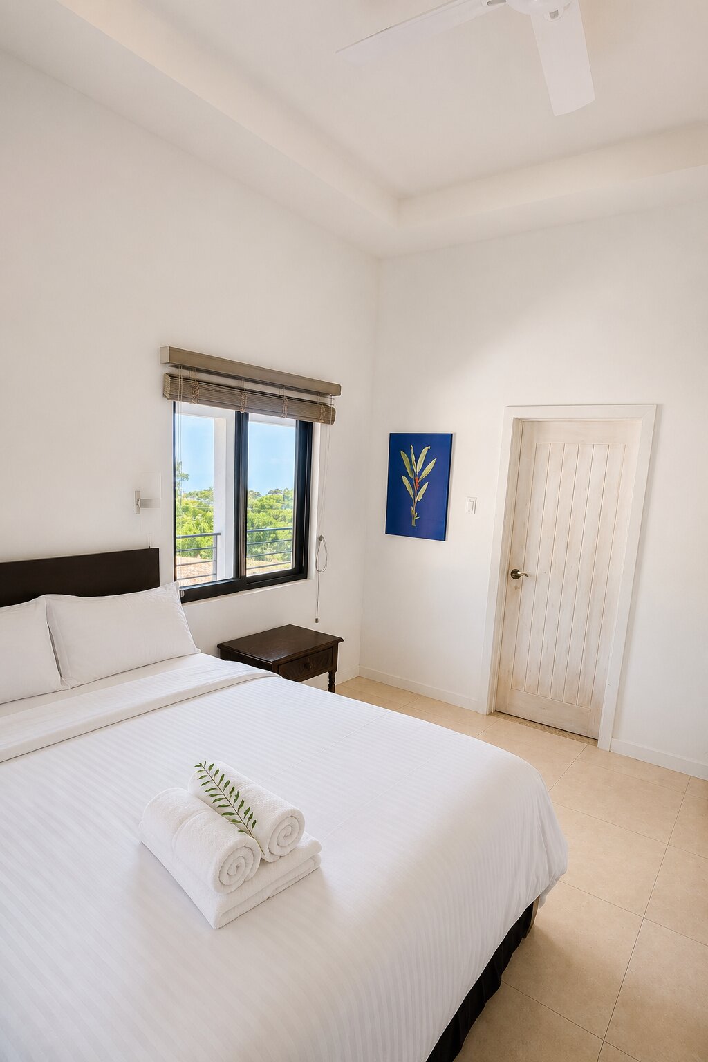 The Heliconia bedroom with a queen bed, window view and heliconia artwork