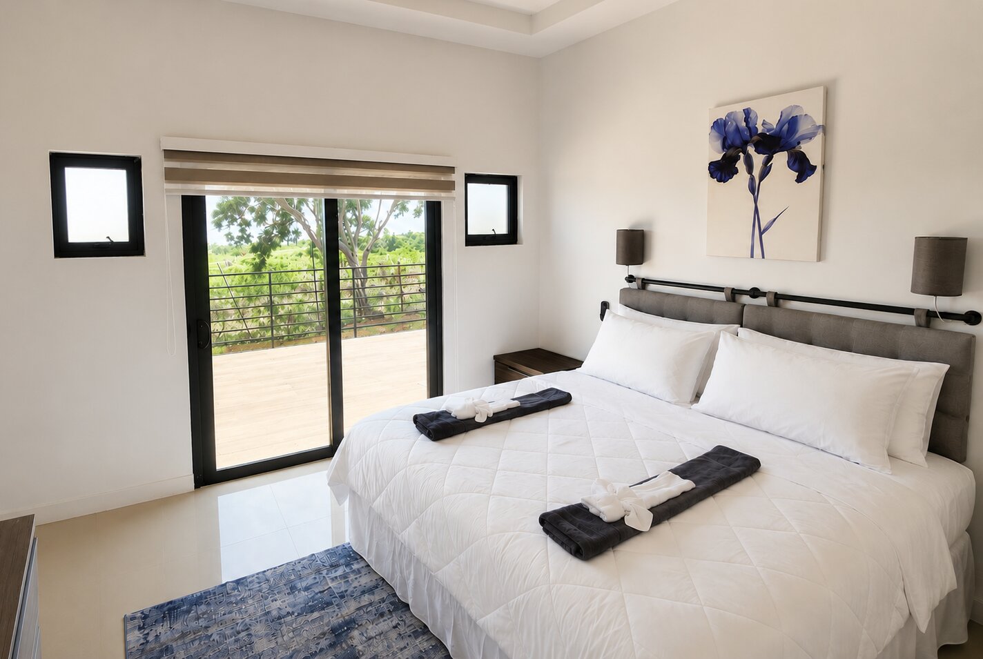 The Iris bedroom with a sliding patio door opening onto the deck and view